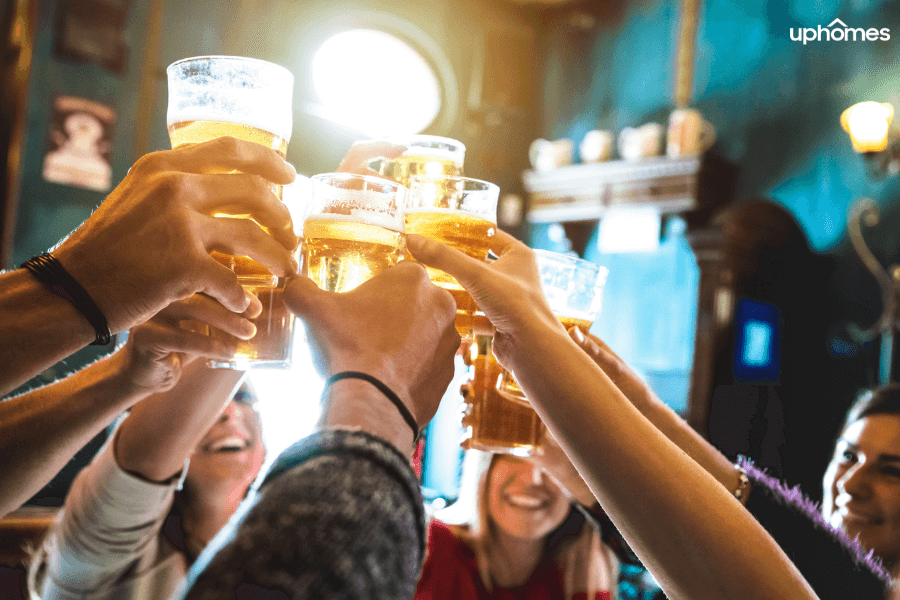 Brewery in Atlanta, GA - Hanging out with friends at the local watering hole for some great times and memories. People cheers-ing their glass of beer in celebration.