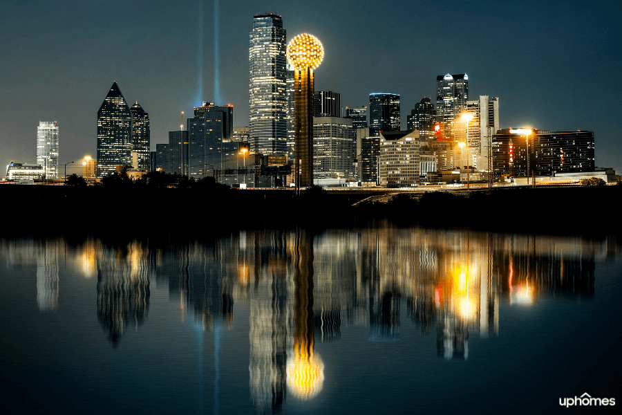 Downtown Dallas TX skyline with the water in the foreground at night time
