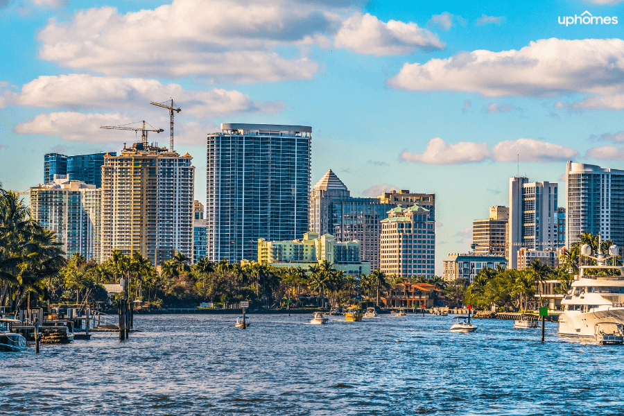 Downtown Fort Lauderdale skyline with water in the foreground and boats on a sunny day