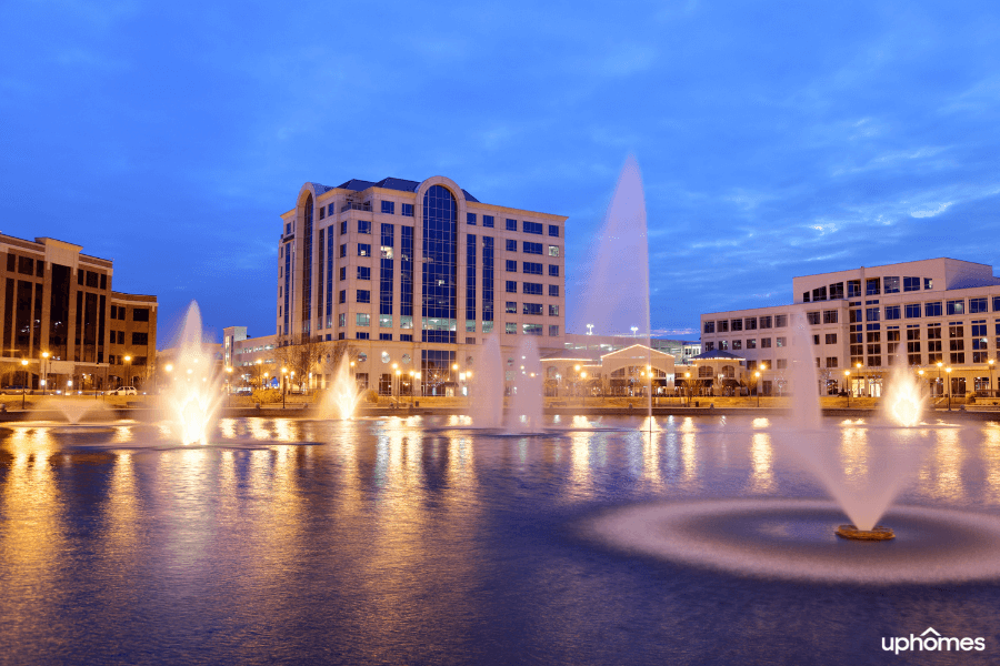 Downtown Newport News at night time with the buildings and water fountain