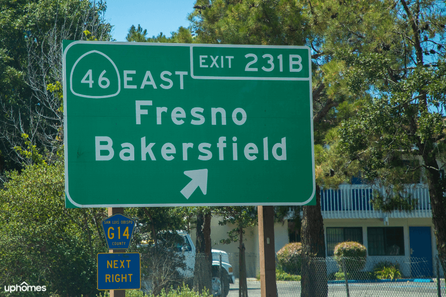 Sign on road that gives directions to either Fresno or Bakersfield California