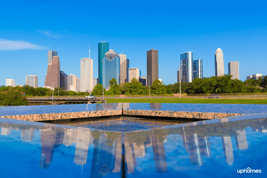 Houston Skyline on a bright sunny day from the park with water in the foreground