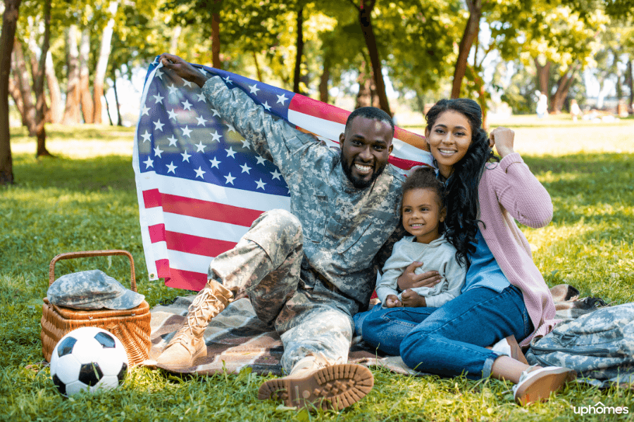 Military family enjoying a picnic in Jacksonville, North Carolina with an American flag mom father and daughter