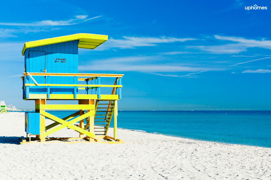 Miami Beach Florida with a life guard station and crystal clear blue water and white sand