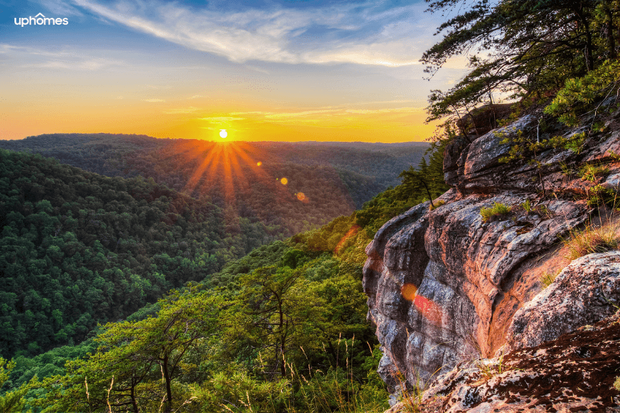 Mountains in Tennessee with the sun setting and a rock/cliff in the foreground