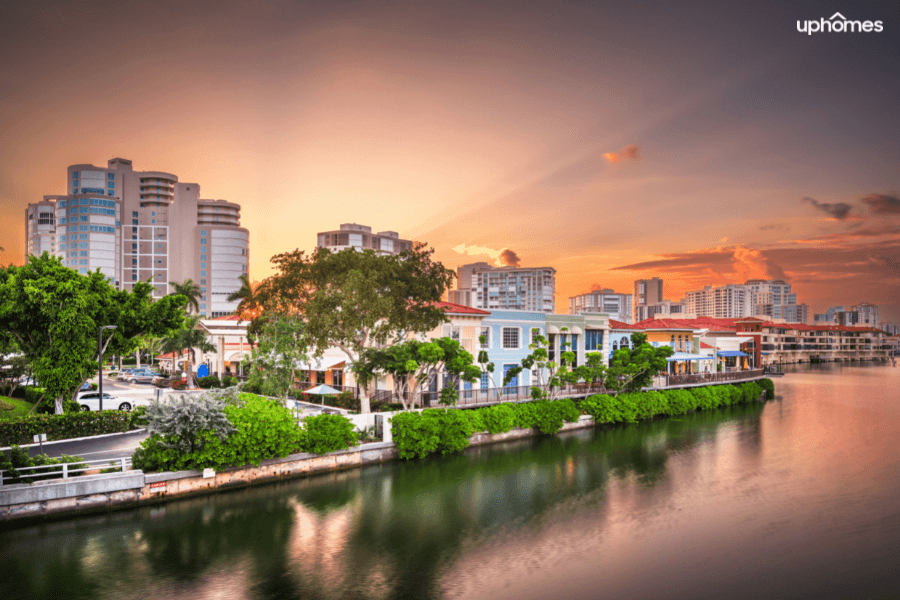 Sunset on the boardwalk in Naples, Florida with a view of the water and city