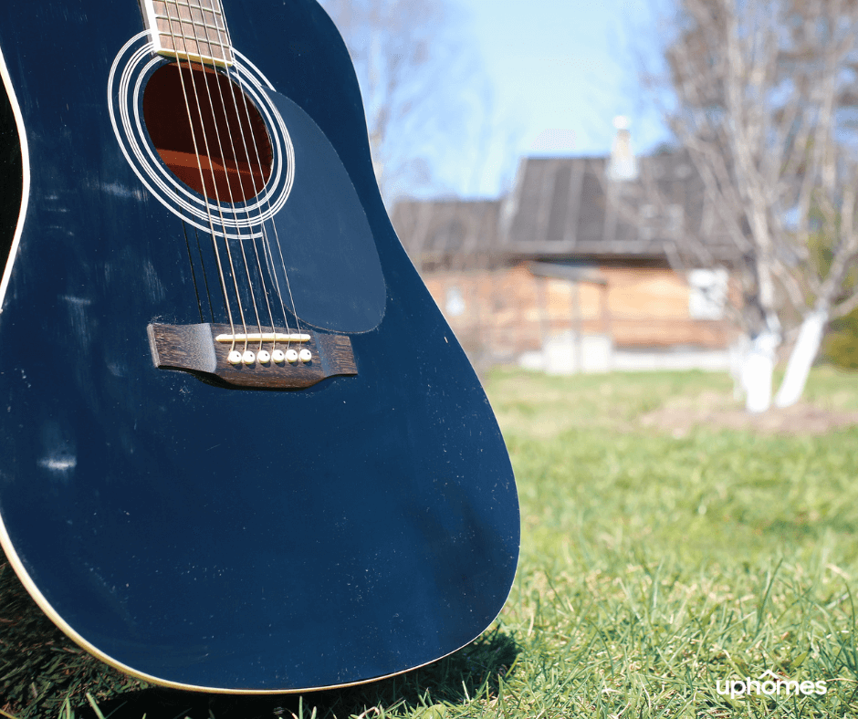 Closeup photo of a Nashville guitar with the city in the background