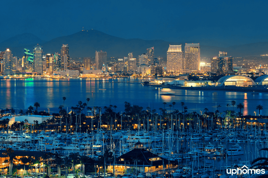 San Diego Harbor at night time with the lights and boats in the water