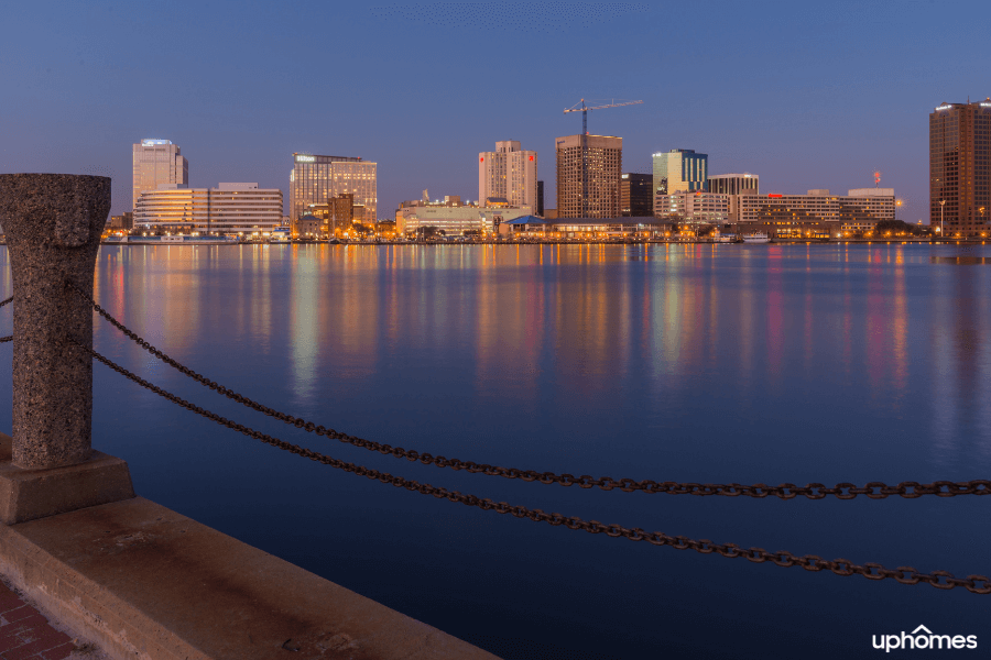 Norfolk Virginia is surrounded by water with a photo of downtown area right along the water and pier
