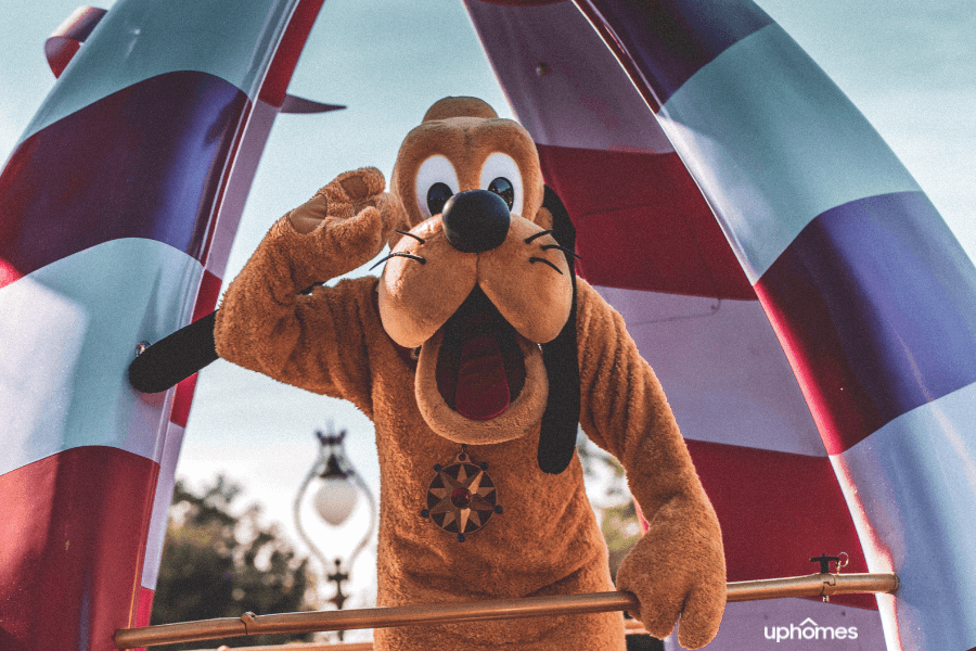 Pluto waving hi to theme park visitors at Walt Disney World in Orlando Florida