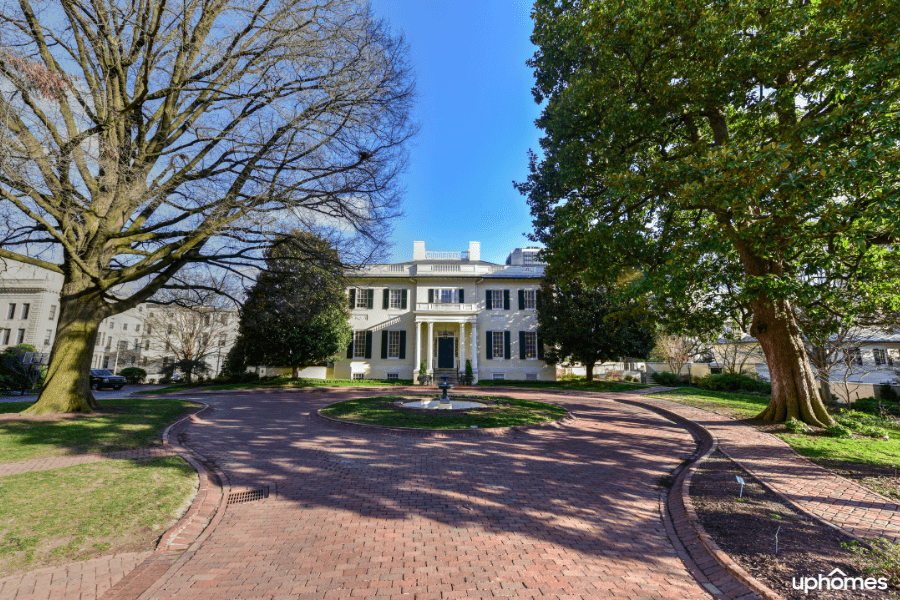 Historic home with red-brick circular driveway leading to the colonial estate