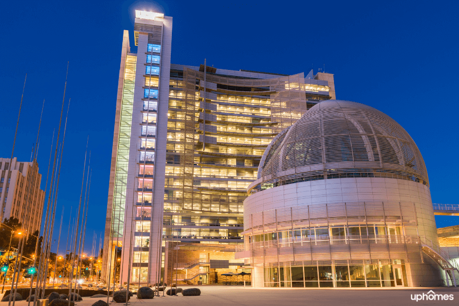 San Jose City Hall at night time with the lights on inside the building