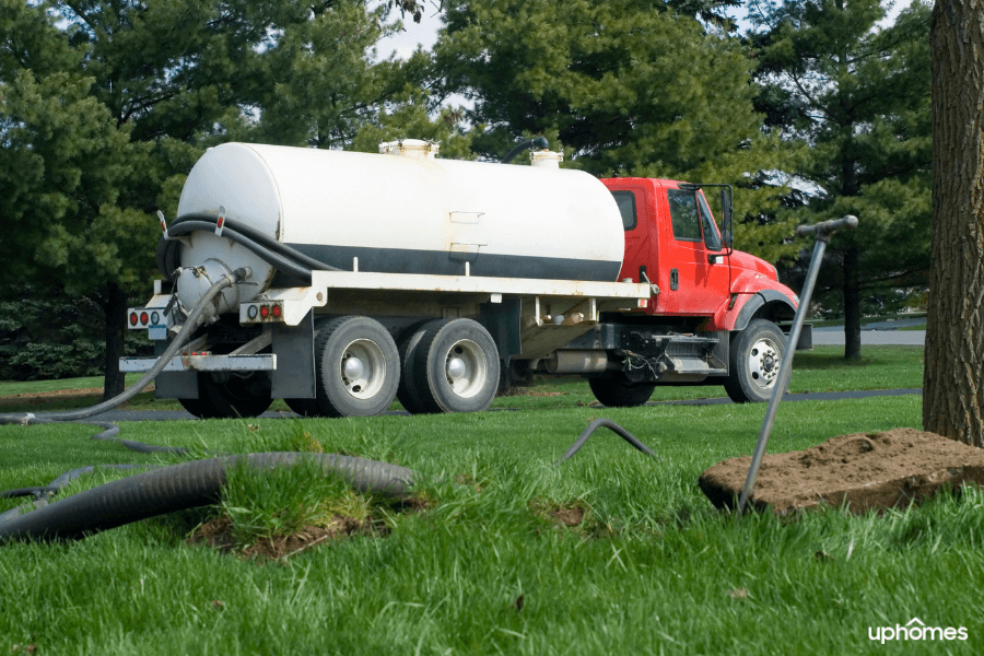 Septic Tank Truck installing a septic tank, repairing a tank, or getting the septic tank pumped in the front yard