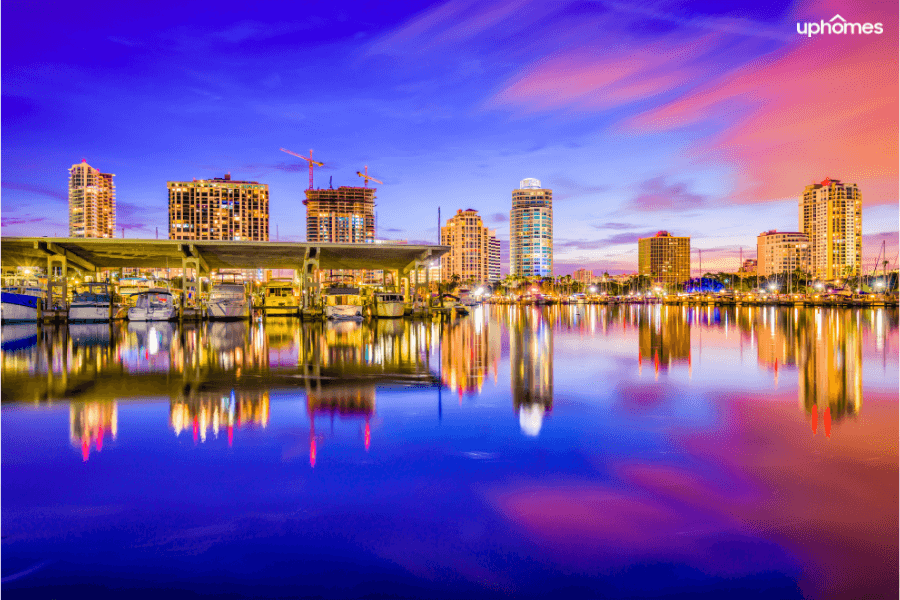 Nighttime view of St Petersburg with boats in the foreground and the downtown skyline in the background at sunset