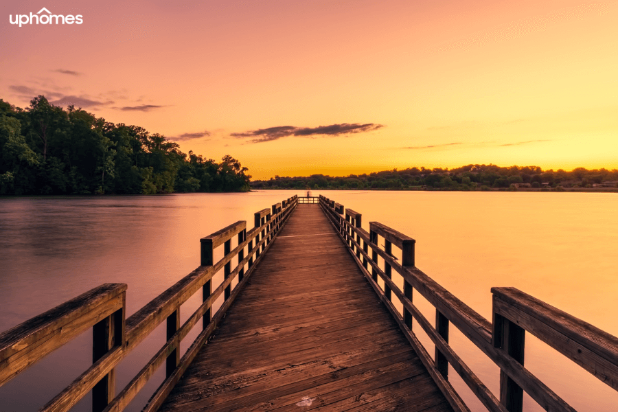 A lake town in Tennessee at sunset with a dock and trees