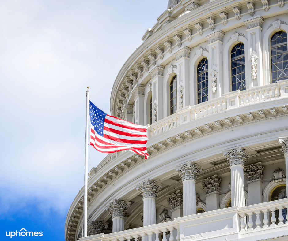 A Washington DC government building that is proudly displaying the united states flag in front blowing in the wind