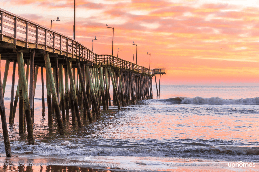 The Virginia Beach pier with waves and a beautiful sunset