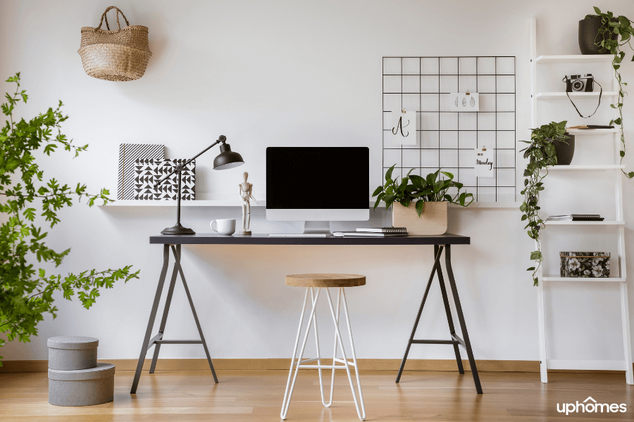 Beautiful Home Office with great lighting, desk, coffee, and many plants to bring up the energy for max productivity