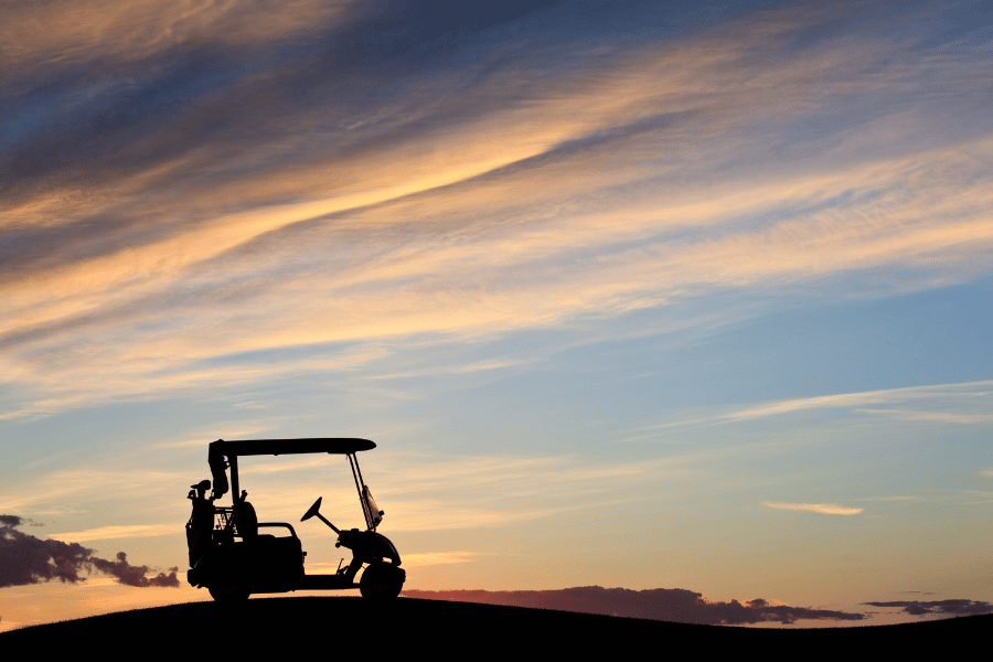 Golf Cart Silhouette during beautiful blue and pink sunset 
