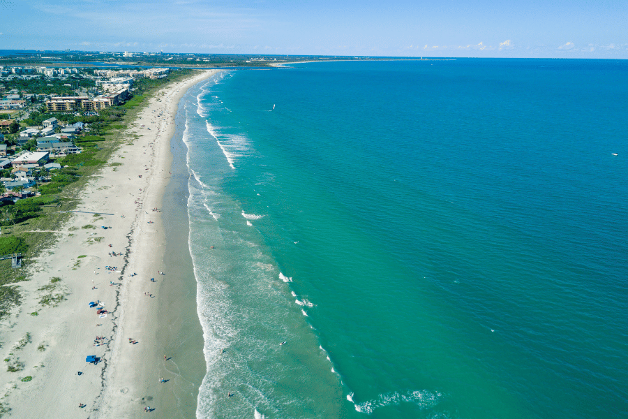 Image of a florida coastline with ariel image of ocean, beach, and the city