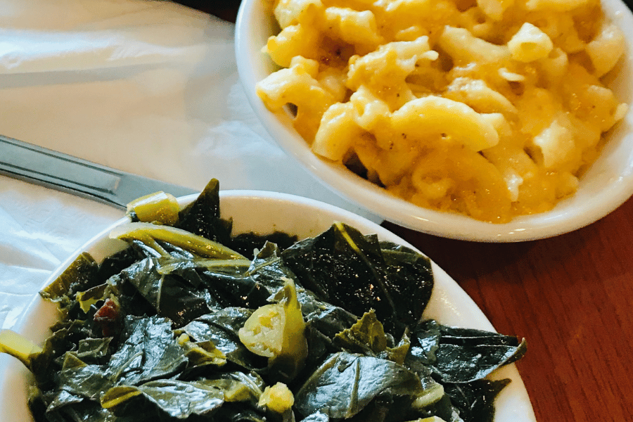 macaroni and cheese and collard greens in bowls