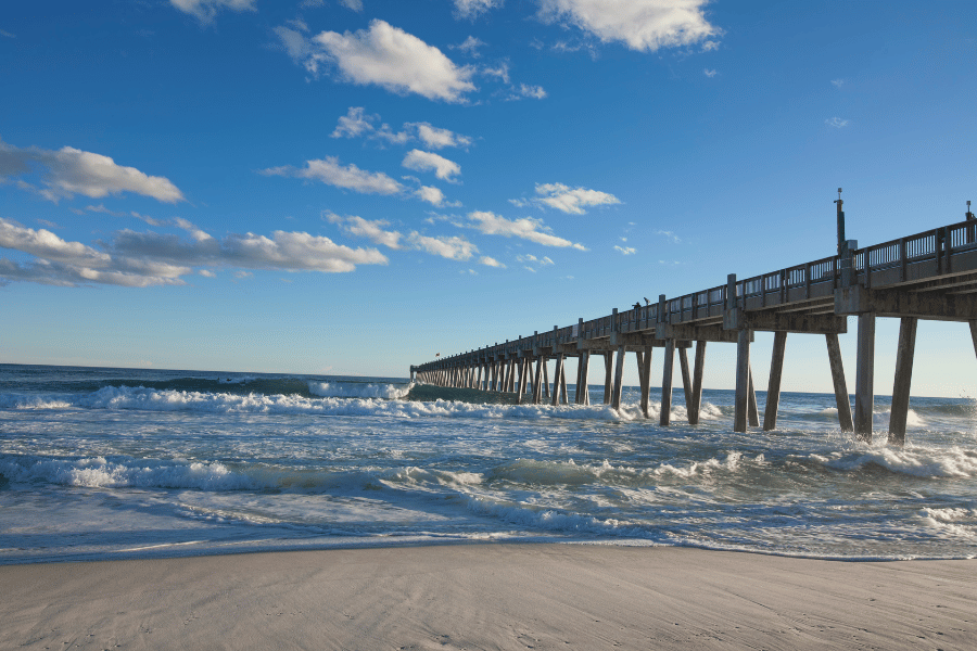 Pensacola Pier on a clear sunny day with rough waves