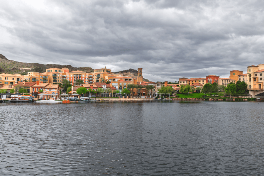 Lake Las Vegas on a cloudy day with orange and tan buildings