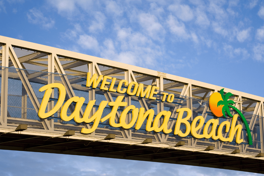 Daytona Beach Sign written in yellow with a palm tree symbol