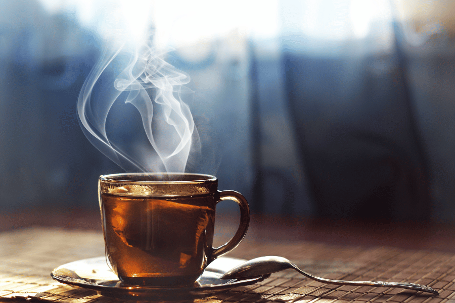 steaming hot cup of tea with spoon