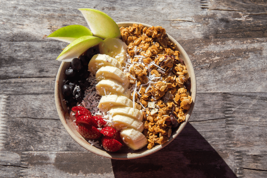 delicious acai bowl on a wood table with toppings