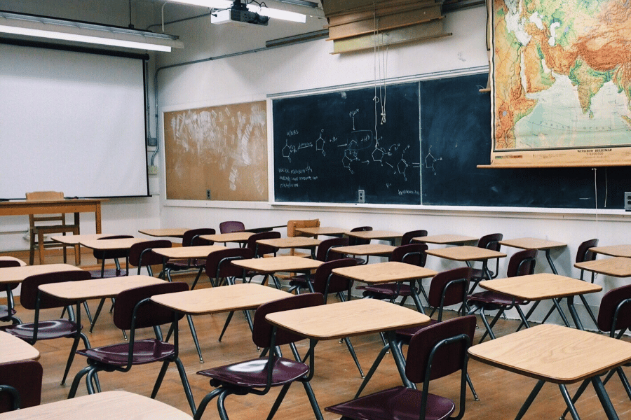 classroom scene with chalkboard and desks