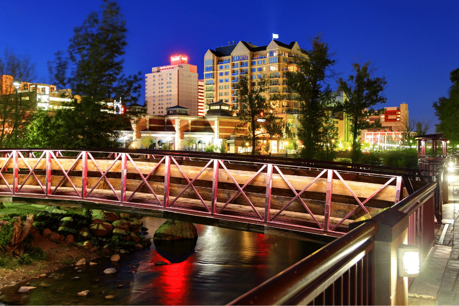 Truckee River at night in Reno, Nevada with a bridge and buildings 