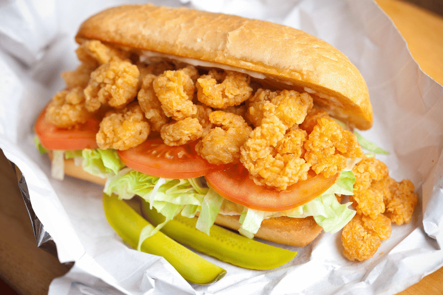 shrimp po boy with lettuce, tomato, and pickles