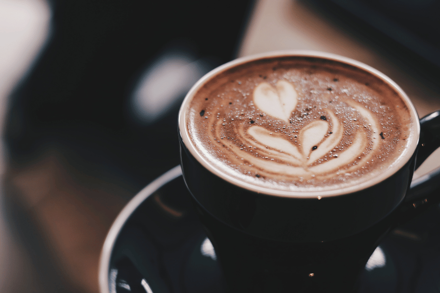 black cup of coffee with latte art 