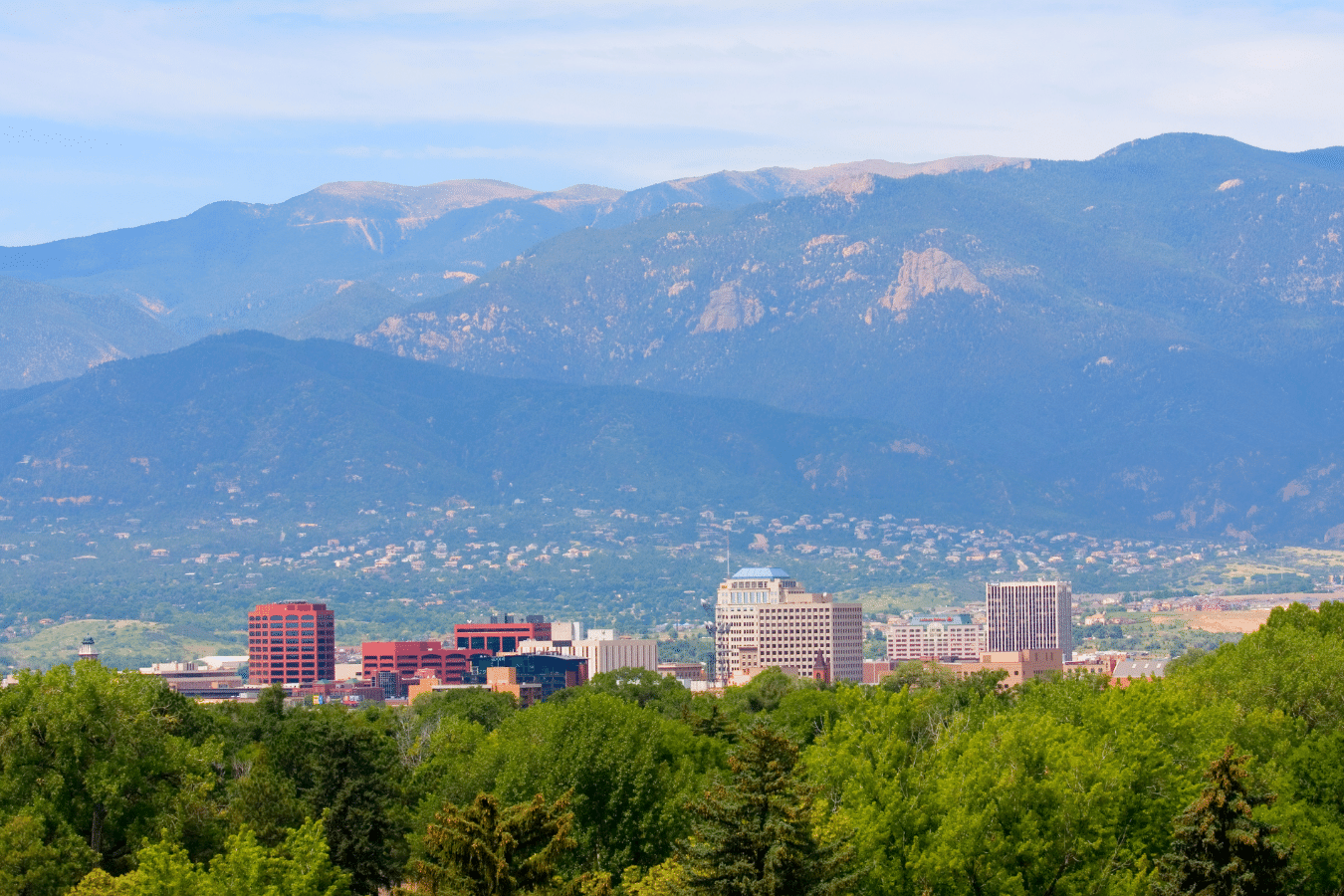 Colorado Springs Downtown during the day time with the Rockies in the background