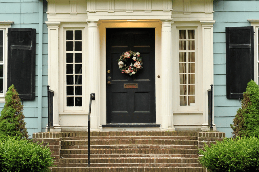 Image of house front steps and door with wreath on front door