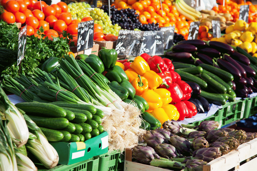 Outdoor farmers market selling fresh vegetables and fruit