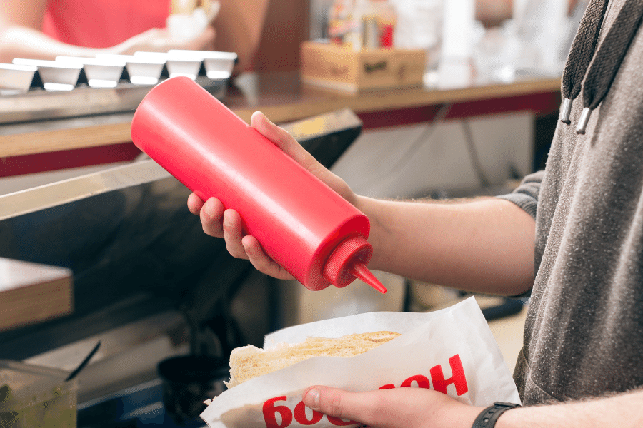 Putting ketchup on a hotdog 