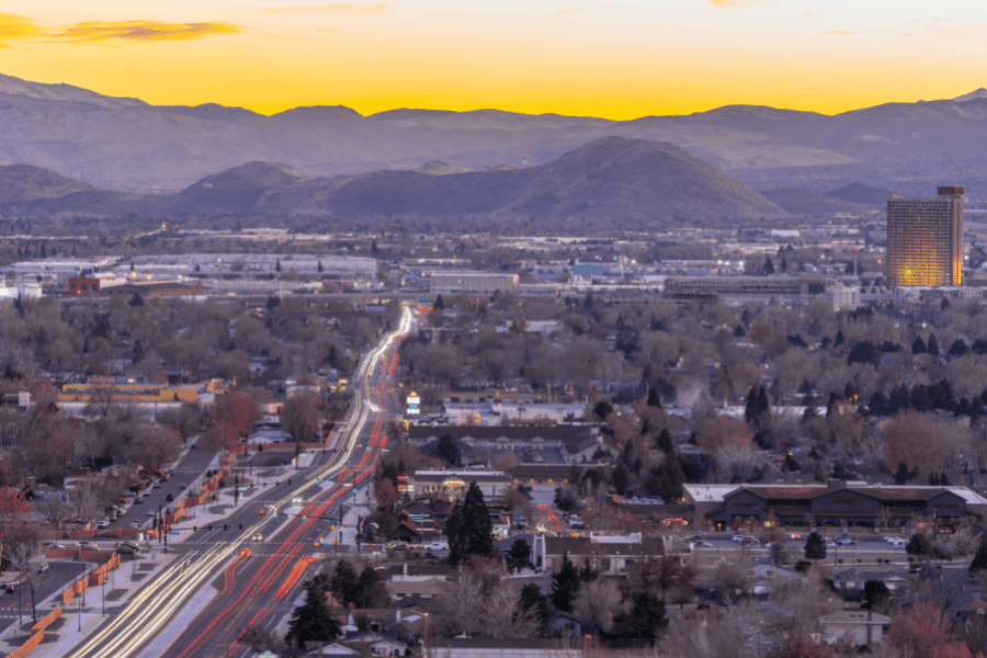 The city of Sparks, NV during the beautiful orange sunset with buildings and lights 