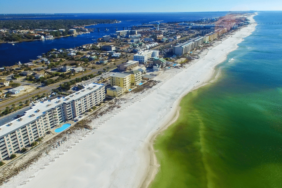 Aerial view of Fort Walton Beach with green water and white sand 