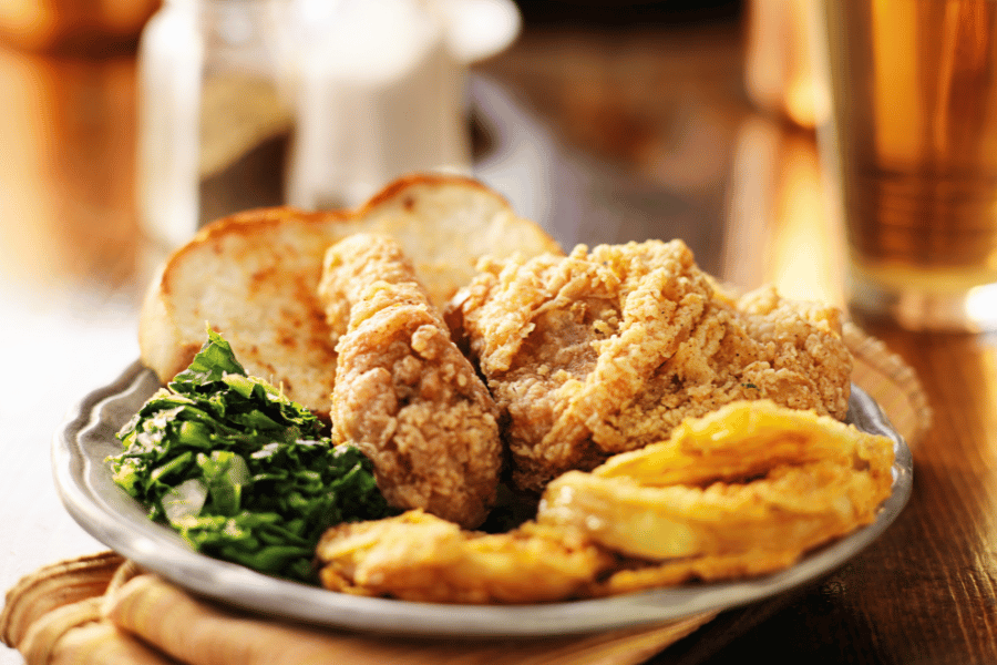 Southern food on a plate with fried chicken and collard greens