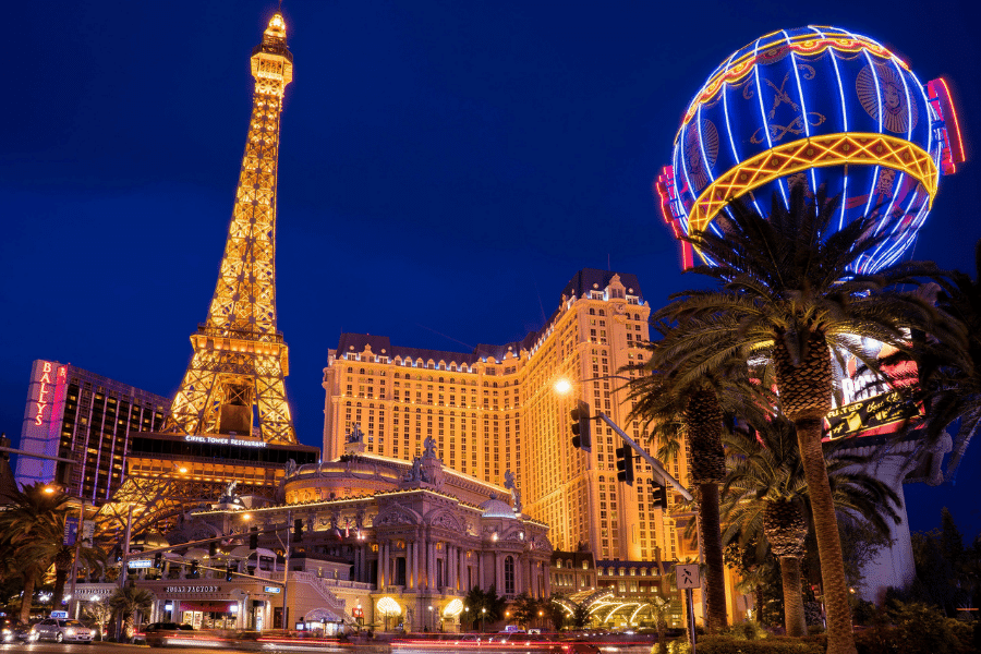 The Las Vegas Strip at night with bright lights in front of the Paris Las Vegas Hotel and Casino