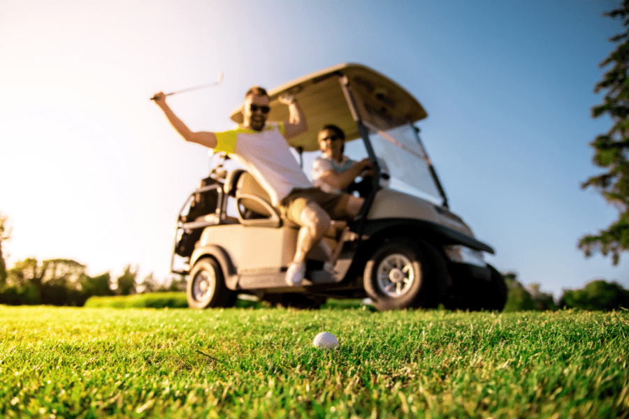 hitting a golf ball from a golf cart 
