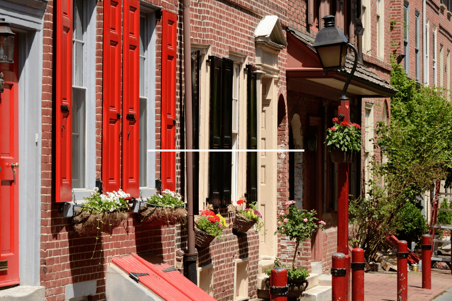 Close up image of homes in Old City Philadelphia with red shutters and brick walls