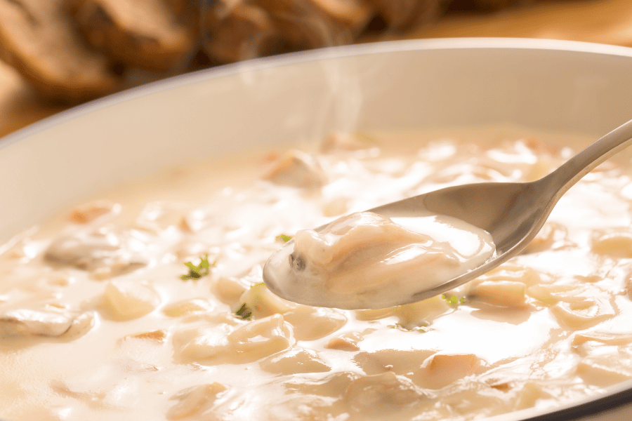 new england clam chowder in a bowl with spoon