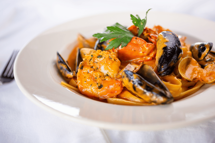 Seafood Fettucine with clams in a white bowl