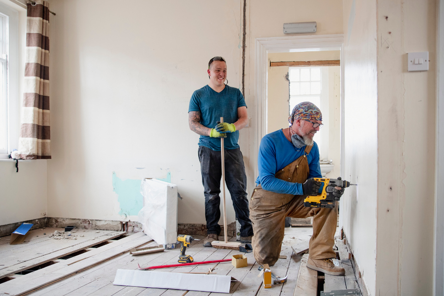 Two workers renovating a home 