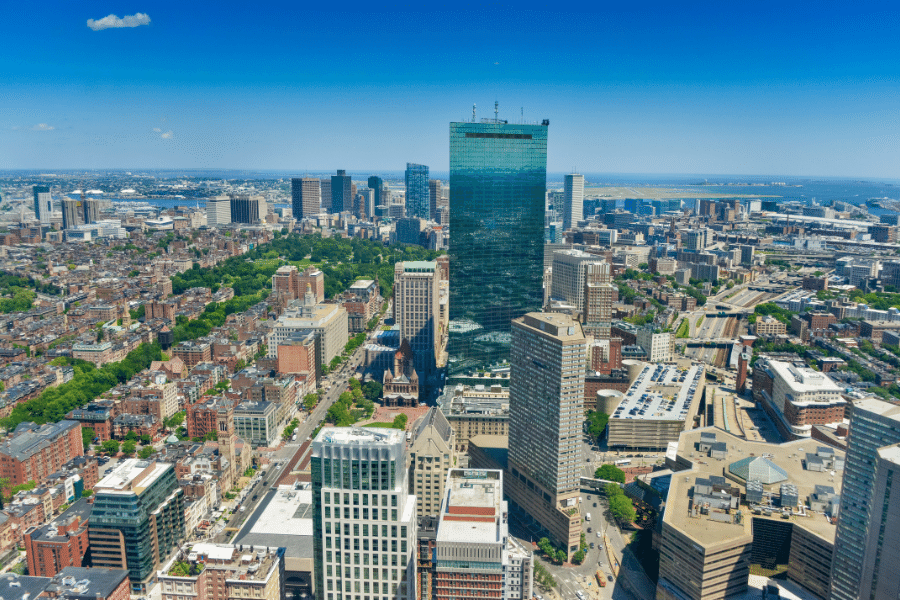 A drone photo of the state of MA with a skyline shot of the entire city of Boston