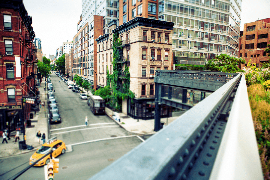 Busy city street in Manhattan, NY with buildings and cars 