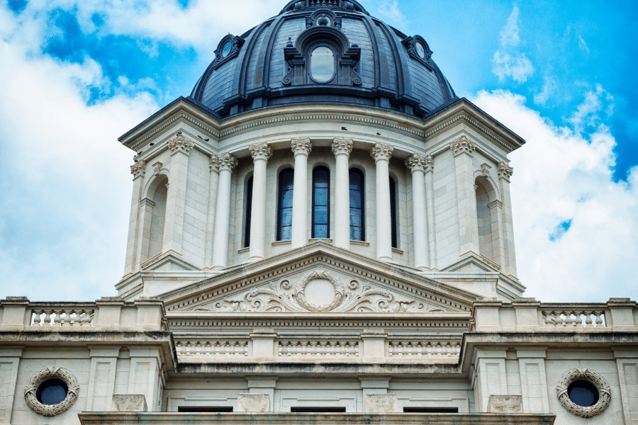The capitol building in South Dakota on a sunny day with clouds